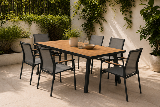 Outdoor dining set with a wooden table and black chairs on a patio.